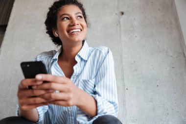 Smiling attractive young african woman wearing shirt