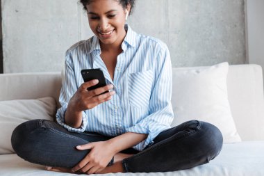 Smiling attractive young african woman wearing shirt