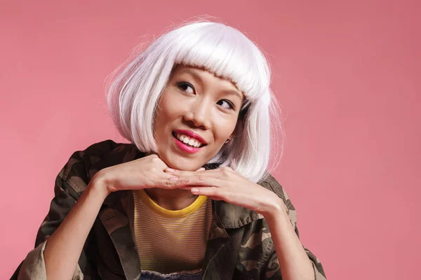 Image of asian girl wearing white wig smiling and looking at cop — Stockfoto