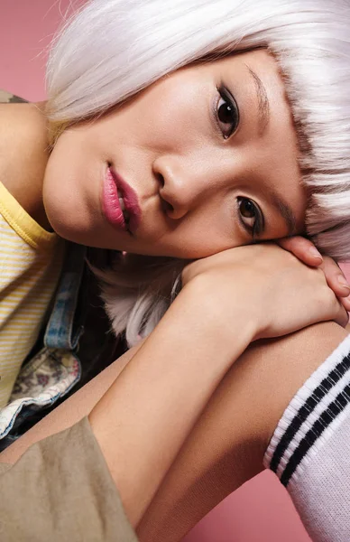 Image of young asian girl wearing white wig sitting with head on — Stockfoto