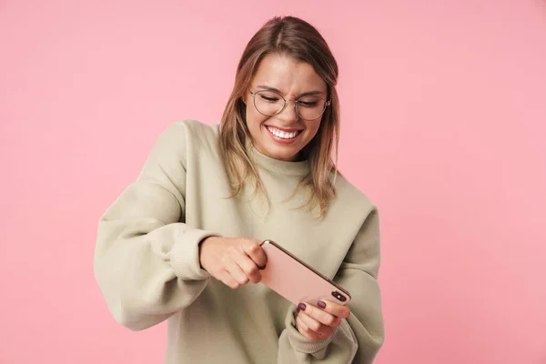 Retrato de agradable mujer emocionada jugando videojuego en el teléfono celular — Foto de Stock