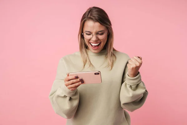 Portrait of nice delighted woman playing video game on cellphone — Stock Photo, Image