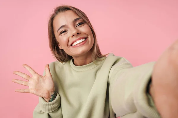 Portrait of beautiful smiling woman waving hand and taking selfie — Stock Photo, Image