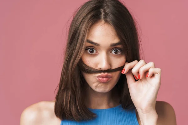 Image of young brunette woman having fun and putting her hair as — Stok fotoğraf