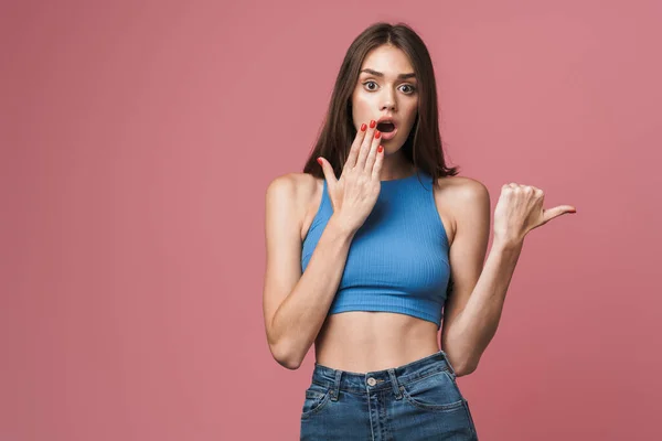 Image of young brunette woman wondering and pointing finger asid — Stok fotoğraf