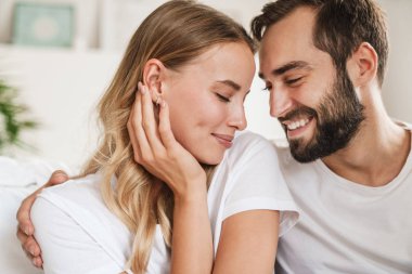 Loving couple indoors at home hugging.