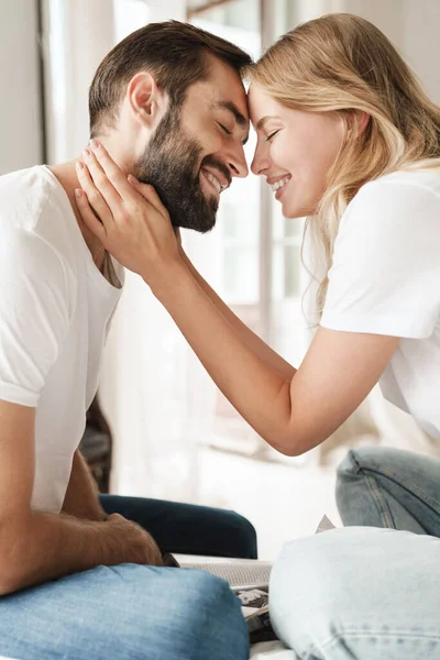 Positive loving couple indoors at home kissing. — Stockfoto