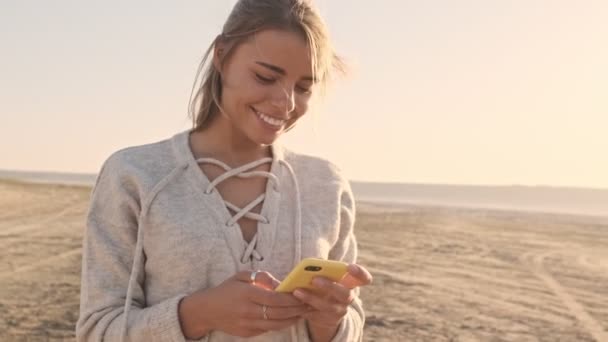 Uma Mulher Sorrindo Feliz Está Usando Smartphone Enquanto Está Lago — Vídeo de Stock