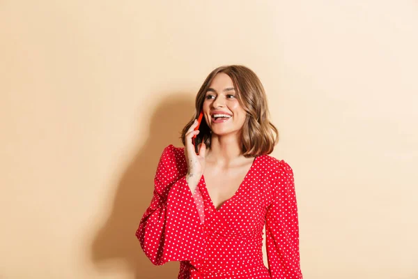 Foto Mujer Complacida Con Vestido Rojo Sonriendo Hablando Teléfono Celular —  Fotos de Stock