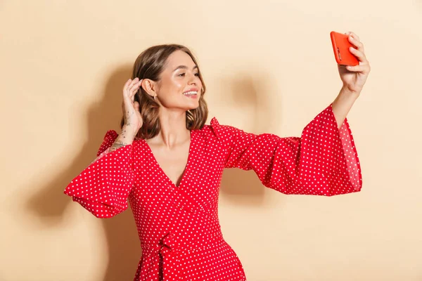 Photo Young Woman Wearing Red Dress Smiling Taking Selfie Photo — Stockfoto