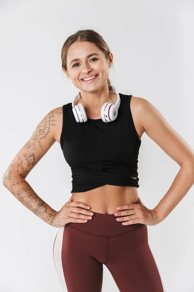 Image Slim Woman Sportswear Smiling Listening Music Headphones Isolated White — Stockfoto