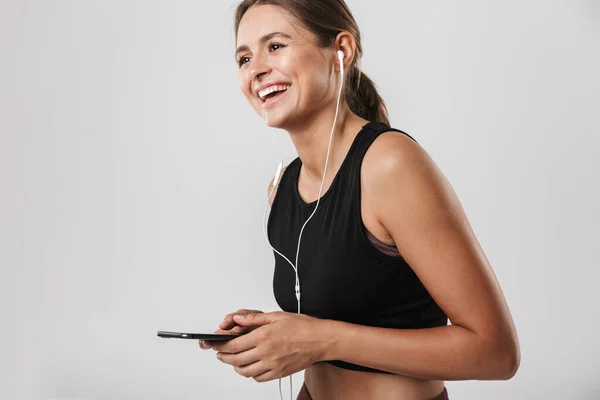 Bild Einer Hübschen Frau Sportkleidung Die Ihr Smartphone Der Hand — Stockfoto