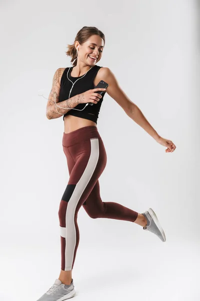 Imagen Mujer Fitness Ropa Deportiva Corriendo Escuchando Música Con Auriculares — Foto de Stock