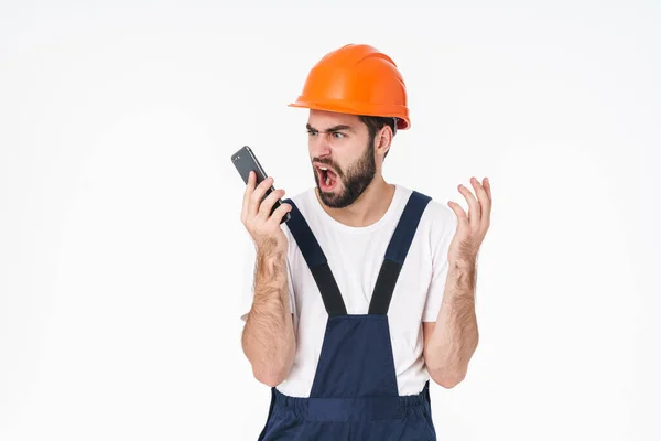 Foto Construtor Jovem Negativo Descontente Capacete Posando Isolado Sobre Fundo — Fotografia de Stock