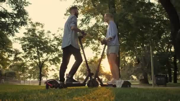 Een Goed Uitziend Jong Koppel Praten Terwijl Elektrische Kick Scooters — Stockvideo