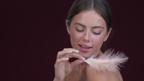 Beautiful Young Woman Touching Her Skin Pink Feather Isolated Dark — Stock Video