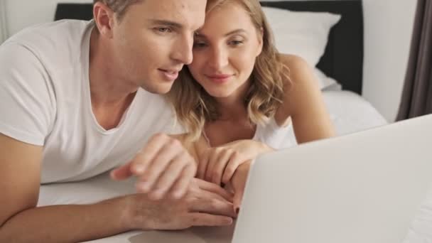 Lovely Young Couple Watching Something Laptop Computer While Lying Bed — Stock Video