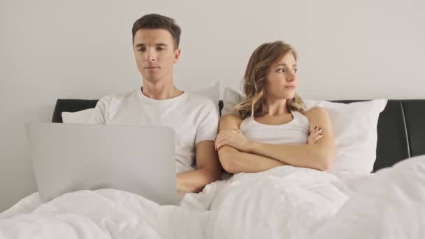 Handsome Boy Using Laptop Computer While His Girlfriend Sitting Crossed — Stock Video