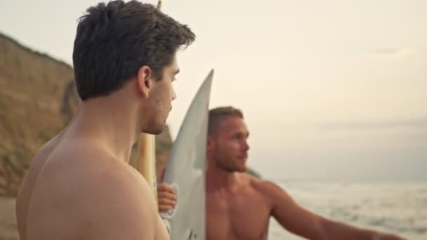 Dos Guapos Surfistas Musculosos Fríos Parados Con Tablas Surf Mirando — Vídeo de stock