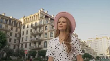 Pembe şapkalı güzel bir bayanın açık havada yürüyüşünün alt görüntüsü.