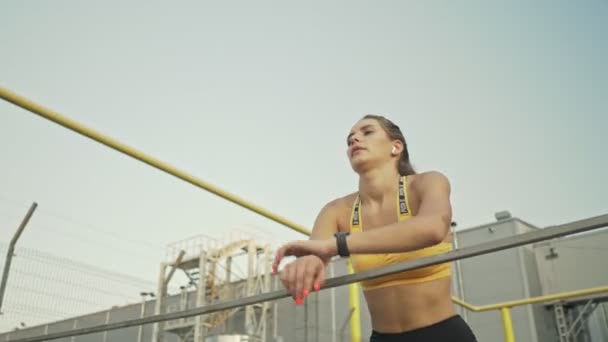 Serious Young Woman Sportswear Using Fitness Tracker While Leaning Railing — Stock Video