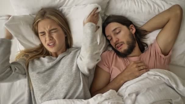 Een Ontevreden Jonge Vrouw Bedekt Haar Oren Met Een Kussen — Stockvideo