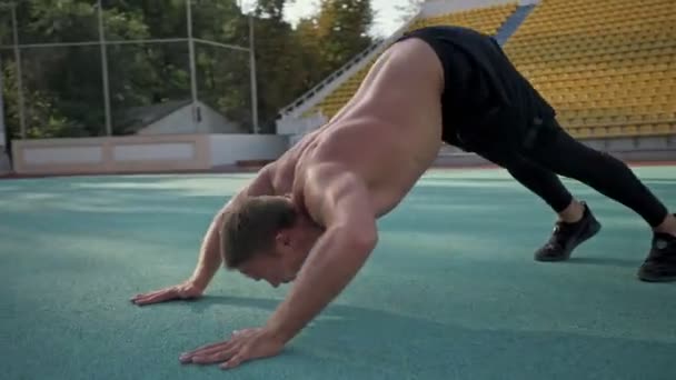 Calm Young Muscular Shirtless Sportsman Doing Stretching Exercises Ground Stadium — Stock Video