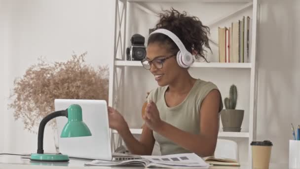 Jolie Femme Africaine Lunettes Écouteurs Écoutant Musique Dansant Assis Table — Video