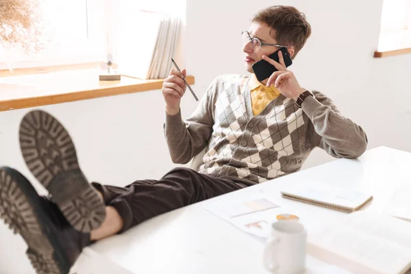 Imagem Jovem Estudante Confuso Sentado Mesa Dentro Casa Falando Por — Fotografia de Stock