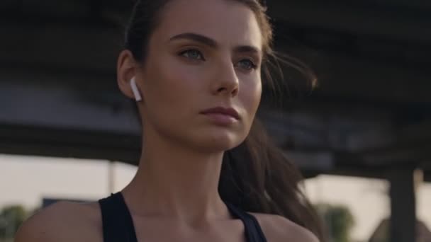 Focused Concentrated Young Woman Earphones Correcting Her Ponytail While Training — Stock Video
