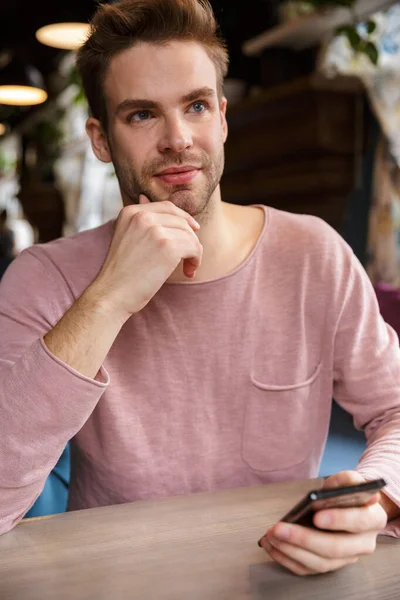 Attractive Young Man Using Mobile Phone While Sitting Cafe Table — Stock Photo, Image