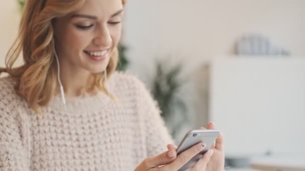 Happy Smiling Young Blonde Woman Using Mobile Phone While Drinking — Stock Video