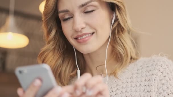 Close View Nice Blonde Young Woman Wired Earphones Using Mobile — Stock Video