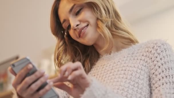 Bottom View Smiling Young Woman Using Her Smartphone While Sitting — Stock Video