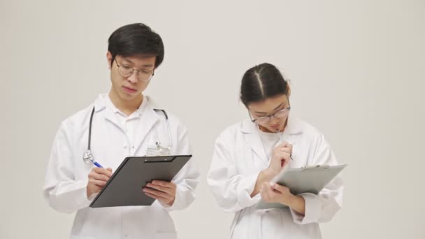 Giovani Asiatici Concentrati Medici Isolati Sfondo Bianco Sterili Appunti Scrittura — Video Stock