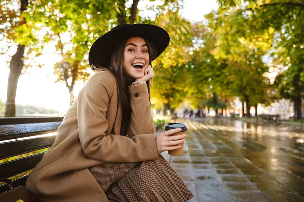 Retrato Mujer Excitada Con Abrigo Sombrero Sentado Banco Con Taza — Foto de Stock