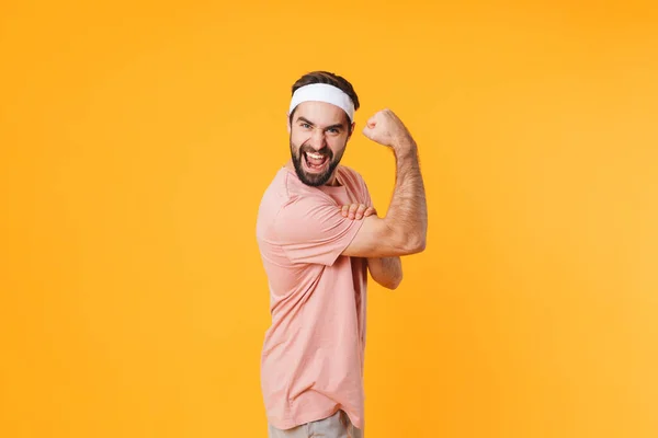 Kép Izmos Sportos Fiatalember Pólóban Szórakozik Mutatja Bicepsz Elszigetelt Sárga — Stock Fotó