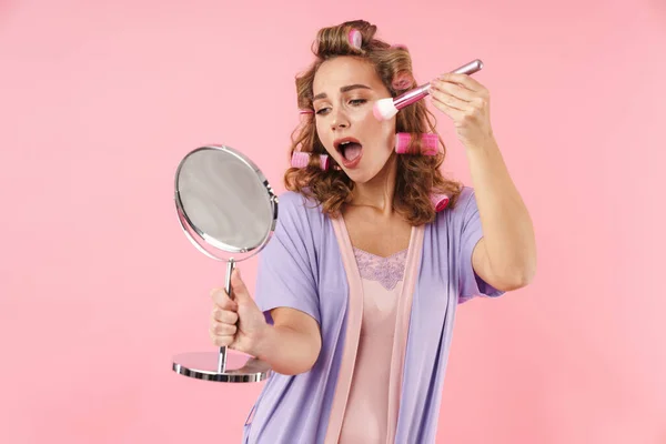 Image Pleased Young Woman Curlers Using Powder Brush Looking Mirror — Stock Photo, Image