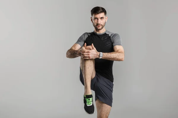 Bild Eines Jungen Athletischen Mannes Sportbekleidung Der Sein Bein Streckt — Stockfoto