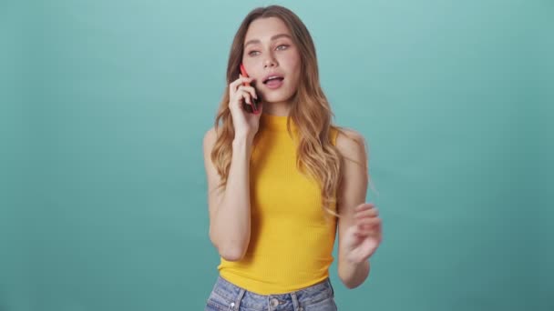 Funny Beautiful Young Girl Excitedly Talking Phone Isolated Blue Background — Stock Video