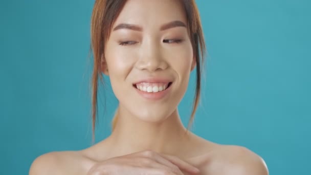 Nice Pretty Asian Woman Tenderly Touching Her Collarbone Isolated Blue — Stock Video