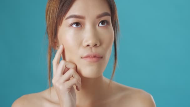 Serious Asian Woman Thinking Something Isolated Blue Wall Background — Stock Video