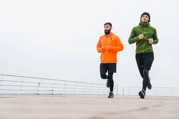 Two Motivated Young Sportsmen Jogging Outdoors Seaside — Stock Photo, Image