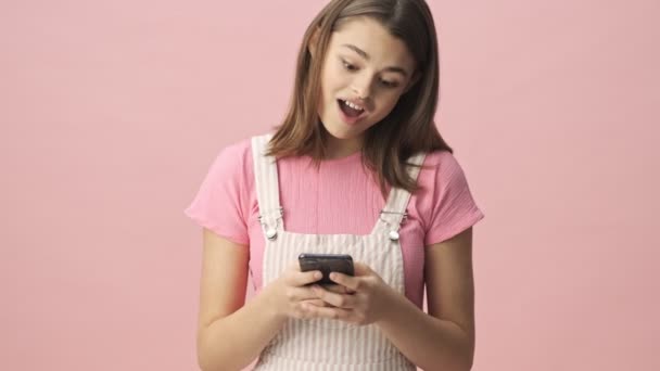 Calm Pretty Brunette Woman Overalls Using Smartphone Becoming Surprised Pink — Stock Video