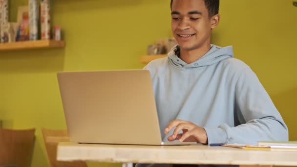 Positiv Fröhlicher Junger Afrikanischer Junge Studiert Hausaufgaben Mit Laptop Computer — Stockvideo