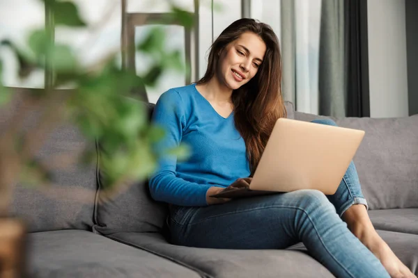 Imagem Sedutora Jovem Mulher Feliz Usando Laptop Sorrindo Enquanto Sentado — Fotografia de Stock