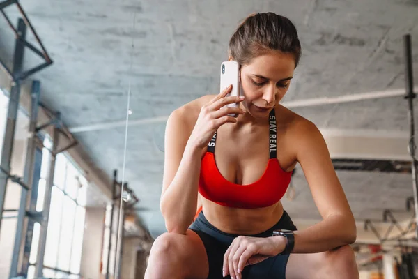 Portrait Focused Young Sportswoman Talking Cellphone Using Smartwatch While Working — Stock Photo, Image