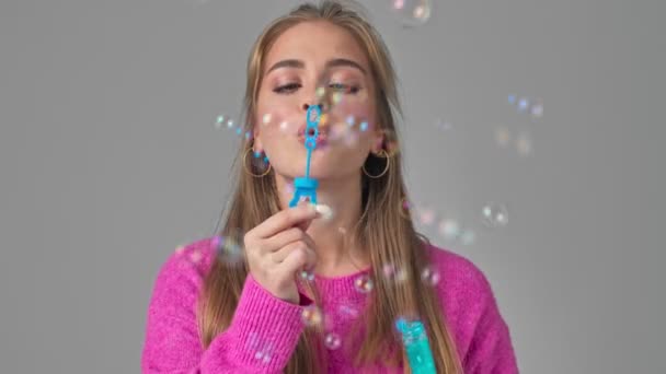 Uma Jovem Sorridente Feliz Está Soprando Bolhas Isoladas Sobre Fundo — Vídeo de Stock