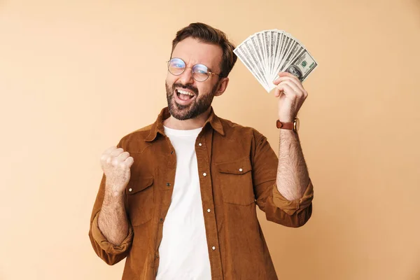 Image Excited Positive Young Unshaved Man Isolated Beige Wall Background — Stock Photo, Image