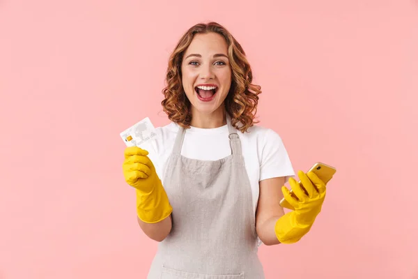 Image Happy Excited Young Housewife Woman Gloves Holding Mobile Phone — Stock Photo, Image